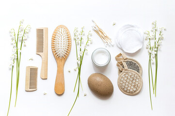 Eco cosmetic products and supplies for personal hygiene. Glass jar of organic cream lotion, reusable cotton pads, wooden combs and bamboo ear sticks. Sustainable lifestyle. Zero waste, plastic free. 