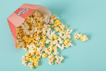 Front view of popcorn inside the package; some scattered in the background.