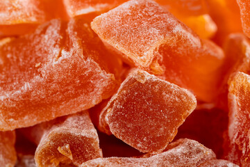 Close-up of Natural farm homemade candied pumpkin fruits sprinkled with powdered sugar, food background, texture