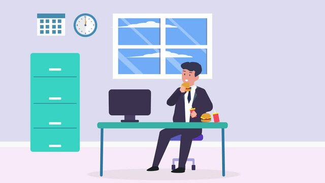 Businessman working at office while eating burger