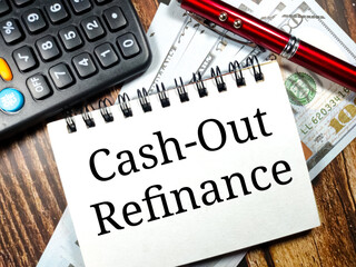 Business concept.Text Cash-out Refinance with banknote,pen and calculator on wooden table...