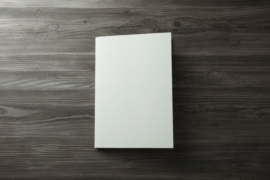 Blank paper brochure on wooden table, top view. Mockup for design