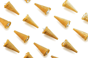 Sweet waffle cones with filling. Waffle cones with white sweet filling, isolated on a white background. The image of a sweet treat.