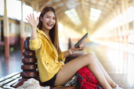 Smiling Female Traveller Say Hi And Showing Five Palm Leaves Hand To Camera At Terminal