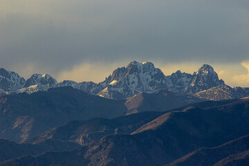 sunset over the mountains, dusk in the mountains, Snow capped peaks at dusk