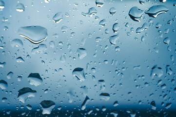 Rain drops on window glasses surface with sunset. drops on glass spray on window background for dark text view selective focus