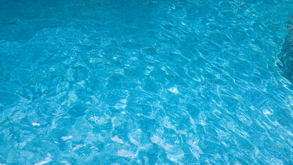 Abstract pool water.  Swimming pool bottom caustics ripple and flow with waves background surface of blue swimming pool