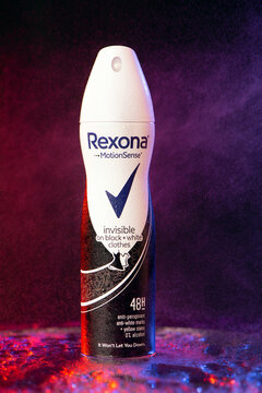 Rexona Motionsense antiperspirant deodorant in neon red blue on a black background with splashing water. freshness concept