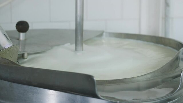 Processing milk in stainless steel container in smal dairy - thermal treatment of milk