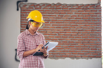 Woman construction engineer wear safety white hard hat at construction site industry worker. Female engineer worker civil engineering with hard hat safety helmet. Woman construction Engineer concept