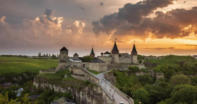 Time lapse of Sunset over the city of Kamianets-Podilskyi. Kamianets-Podilskyi Castle is the fortress located in the histori