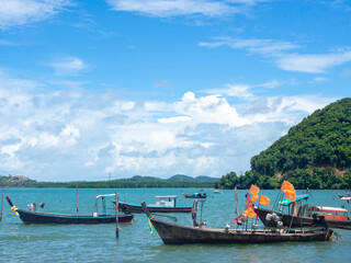 Beautiful seascape summer background. Many local fisherman longtail boat on the sea and sky background on a sunny day in Thailand.