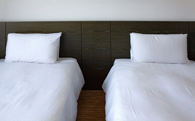 Fototapeta na wymiar Two single beds side by side in the room.