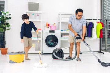 Father teaching asian kid little boy son having fun doing household chores cleaning and washing...
