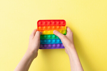 Antistress toy pop it fidget on yellow background.