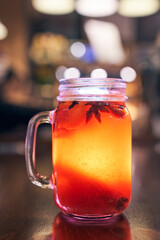 Christmas drink red non-alcoholic mulled wine with a straw on the background of the cafe interior, order for one