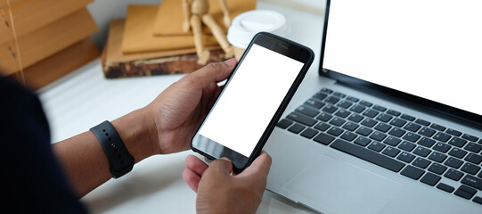 Close up view of businessman holding mock up smart phone with blank screen.	