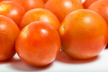 Tomato cherry close up isolated on white background. Macro photograpy.