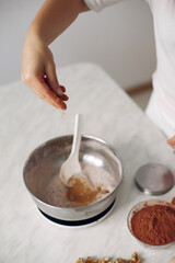 Chef in white clothes prepares a chocolate cake.
