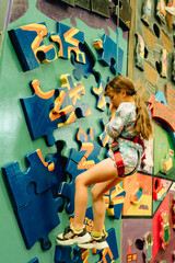 young child girl on indoor climbing wall