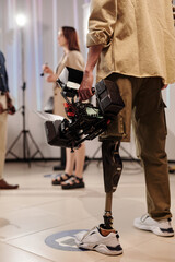 Fototapeta na wymiar Back view of disabled cameraman standing in front of his assistant