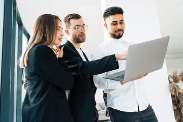 Group of young business people in the office use laptop