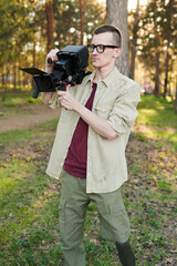 Young disabled opreator shooting video in park