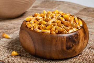 Peruvian Snacks. Fried Corn Seeds in Wooden Bowl.