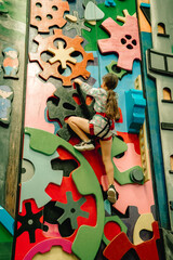 young child girl on indoor climbing wall