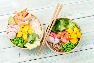 Poke bowls with shrimps, salmon, avocado and mango