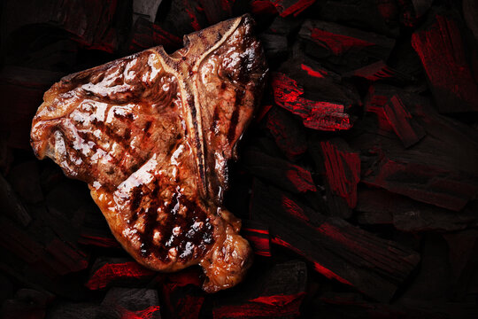 Grilled t-bone steak over hot coal