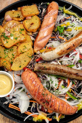 mixed german traditional organic sausage and potato meal platter