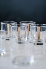 Glass glasses with wicks are on the table.
