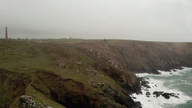 Aerial of a misty moody landscape of the Cornish coastline. 