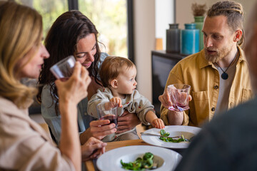 Happy multigeneration family indoors at home eating healthy lunch.