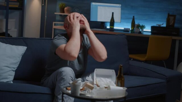 Furious nervous frustrated overwhelmed by problems man screaming, throwing away mobile receiving bad news from bank, having nervous breakdown feeling annoyed, desperate reading digital eviction notice