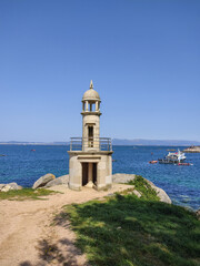 Fototapeta na wymiar lighthouse in the sea in summer