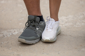 Naklejka premium comparativa entre las zapatillas de un hombre gigante y una mujer normal.. 