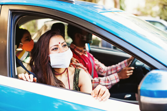 Happy Indian Family Wearing Coronavirus Protective Face Masks Traveling In A Car Together