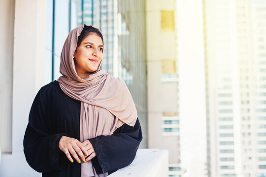 Beautiful Muslim Indian Woman In Hijab Smiling Over Dubai City Background