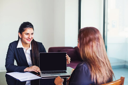 Indian Woman In Formal Suit Showing Laptop With Empty Screen To The Client