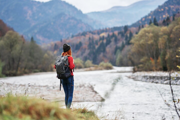 Naklejka na ściany i meble woman travel tourism mountains landscape lake river autumn