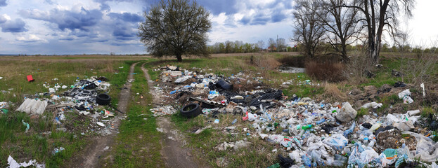 Piles of garbage in the meadow. Environmental protection problems background.