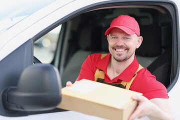 Delivery service driver offers package from his van