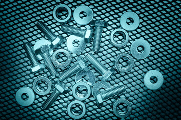 Bolts and nuts on steel surface. Mechanic items for maintenance. Hardware parts to build and repair. Technical tools background