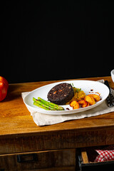 Black pudding with green asparagus and fried apple