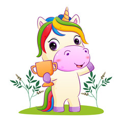 The happy unicorn is holding a golden trophy in the garden