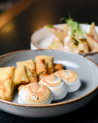 Close up of french style sweet crepes with soft cream served with a tall glass of coffee latte on a wooden table.