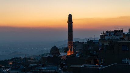 Mardin, Turkey - January 2020: Mardin cityscape at sunset with minaret of Ulu Cami, also known as...