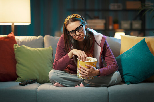 Woman watching a boring movie on TV © stokkete